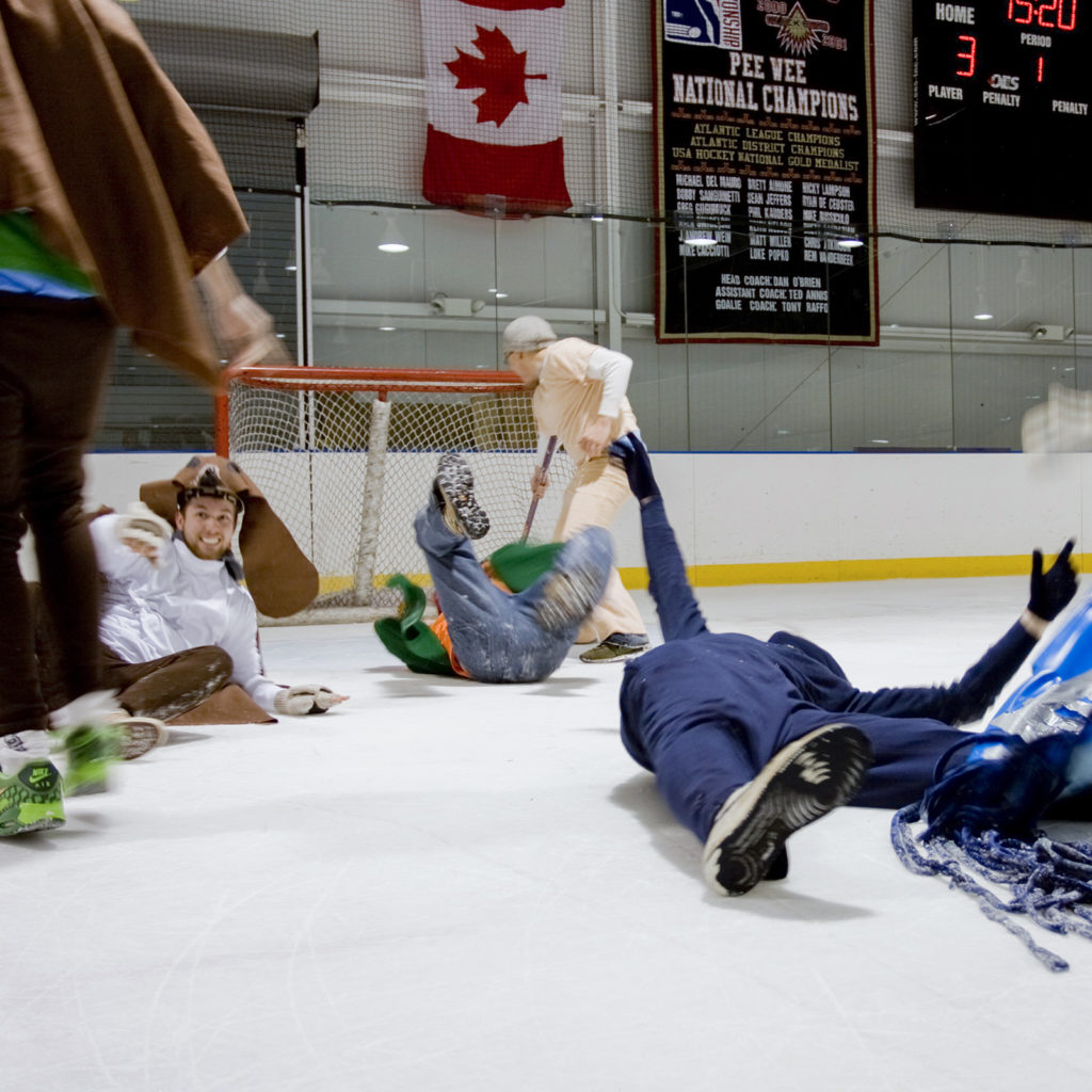hockey players in unique costumes active on ice staking ring.