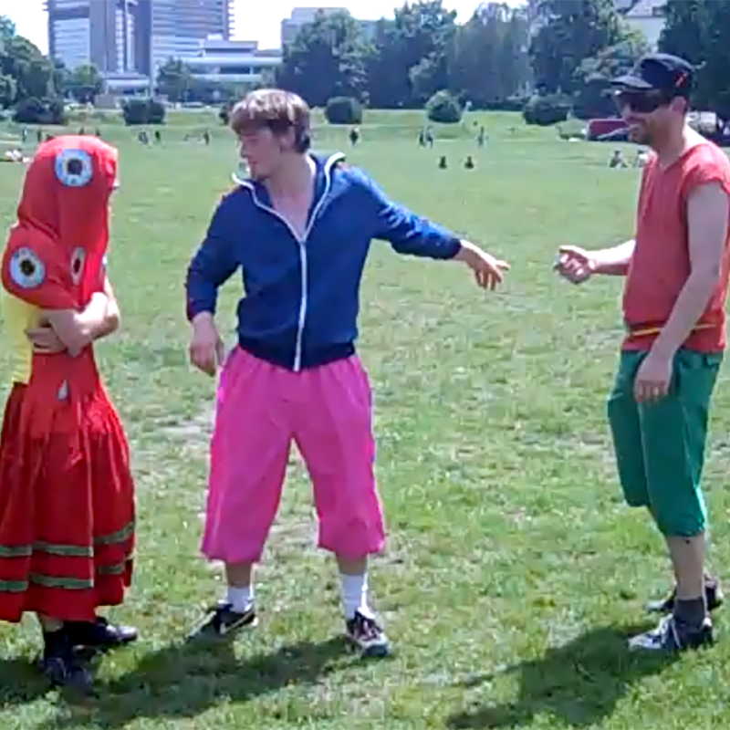 Three players in unique colorful costumes on a green field